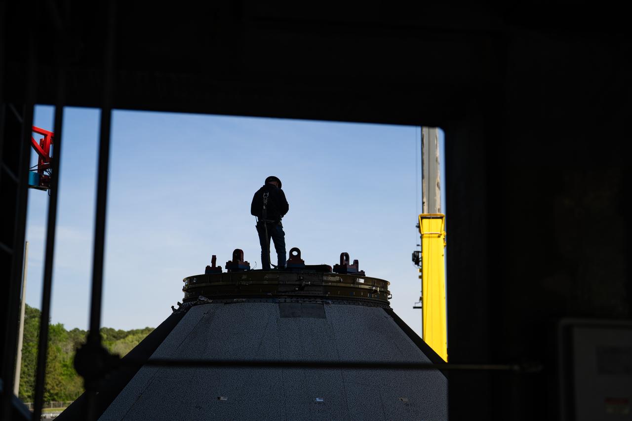 Technicians at NASA’s Marshall Space Flight Center in Huntsville, Alabama, are seen in these images taken April 17, 2025, moving the payload adapter test article from Building 4697 to Building 4705 for storage. This move marks the end of structural testing for the test article. Next, engineers will complete the qualification article and conduct additional for further testing before building the final flight hardware. Manufactured at Marshall, the test article underwent extensive and rigorous testing to validate the design before engineers finalized the configuration for the flight article. The newly completed composite payload adapter is an evolution from the Orion stage adapter to be used in the upgraded Block 1B configuration of the SLS (Space Launch System) rocket, debuting with Artemis IV.